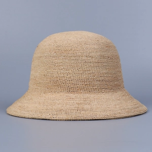 Detailed weave of handmade Raffia straw cloche hat in natural beige for sun protection