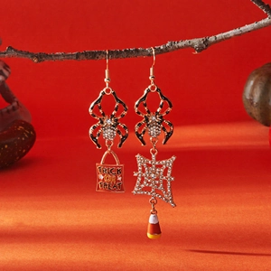 Detailed Halloween earrings featuring spiders and candy bags on orange background