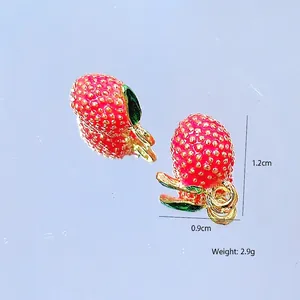 Macro detail of strawberry alloy charms with dimensions 1.2cm by 0.9cm and weight 2.9g
