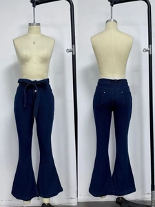 Detail of high waisted flare jeans in dark blue with retro lace-up front and bell bottoms