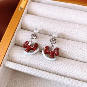Silver horse drop earrings with zircon and red enamel inlay in a luxury jewelry box