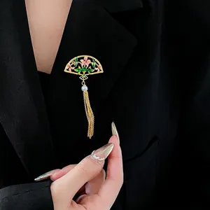 Exquisite 18K gold plated fan brooch with enamel flowers, pearl, and tassel on black blazer