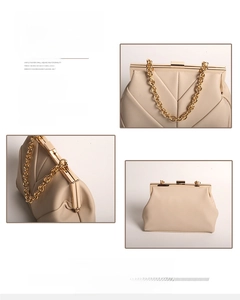 Detail of cream evening clutch bag featuring gold chain and vintage V-quilted pattern