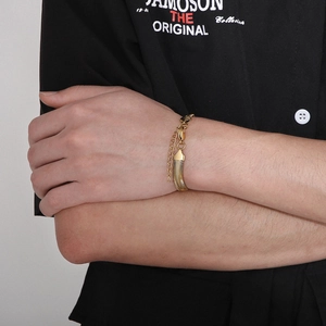 Detail of a minimalist gold snake chain bracelet with adjustable lobster clasp on wrist