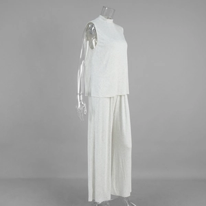 Detail view of light grey knit two-piece set featuring high-neck top and wide-leg pants