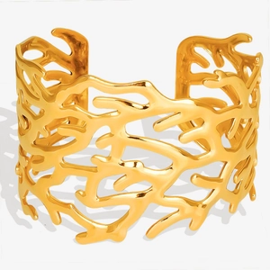 Detailed view of the 18K gold-plated C-shaped cuff with organic hollow coral branch design