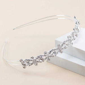 Close-up of sparkling clear rhinestones on a slim silver metal wavy headband for women
