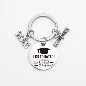 Close-up of Class of 2026 graduation keychain with engraved humorous slogan and charms