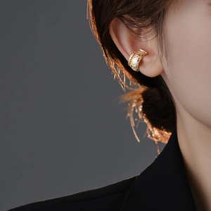 Close-up of gold zircon ear cuff on ear showcasing minimalist style and placement