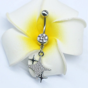 Detail of silver belly ring with star pendant and sparkling cubic zirconia on frangipani