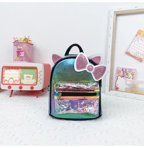 Detail of cute cat ear backpack with rainbow sequins and glitter bow for girls