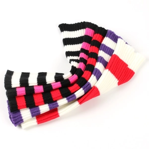 Close-up of five striped knit leg warmers in various colors displayed on white background