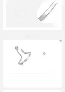 Detailed view of silver snake ring with green eyes and zircons showing 1.5mm width