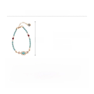 Detail view of turquoise beads and red zircon bracelet with adjustable gold extension
