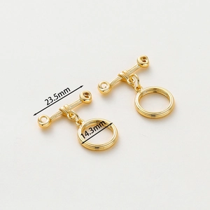 Macro detail of 14k gold-plated OT toggle clasp showing 23.5mm T-bar and 14.3mm ring