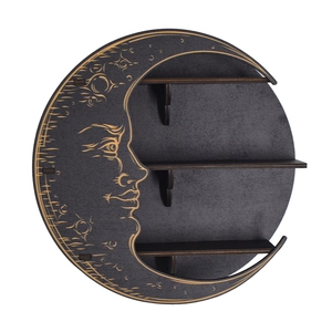 Detail of a black crescent moon wooden shelf with golden engraved moon face features