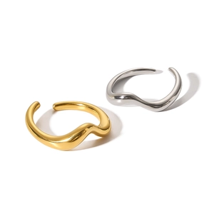 Detailed view of wave-shaped open rings in polished gold and silver finishes