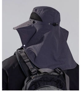Detail of outdoor sun hat with black mesh vent and wide neck flap in dark grey