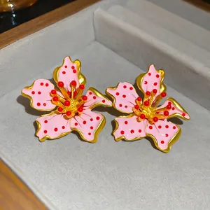 Pink enamel flower earrings with red polka dots in a premium wooden jewelry box