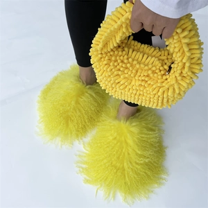 Detailed close-up of bright yellow plush handbag and matching oversized fuzzy slippers