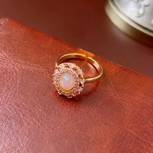 Adjustable gold plated ring with opal center stone and double cubic zirconia halo
