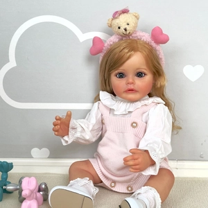 Lifelike 55cm reborn baby doll with blonde hair in pink knit overalls and white shirt