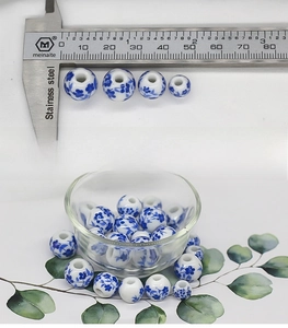 Detailed comparison of various sizes of blue and white floral porcelain beads for DIY crafts