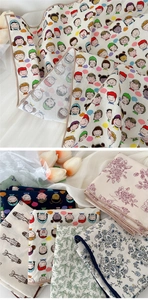 Detailed view of various cotton linen square scarves with cartoon and floral patterns