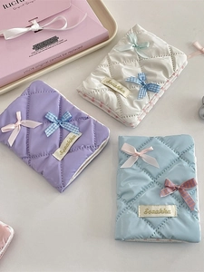 Quilted bow passport holders in pastel purple, white and blue colors for travel