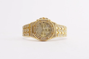 Macro view of gold-plated chronograph watch with iced-out diamond dial and Roman numerals