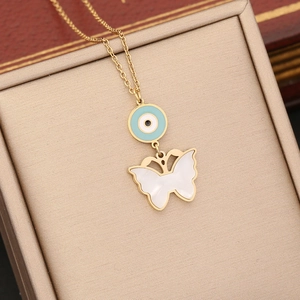 Gold evil eye and white butterfly pendant necklace displayed in a luxury jewelry box