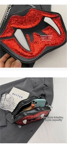 Detail of red sequined lip-shaped bag with silver chain strap and zipper closure