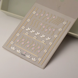 Close-up of 5D daisy nail stickers with golden embossed lines and floral petal details