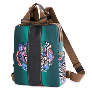 Minimalist green fashion backpack with brown straps and unique colorful print patterns