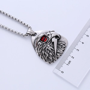 Close-up of owl pendant with red eyes and ruler showing 3.5cm size reference
