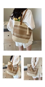Detail of woven straw shoulder bag with PU handles and tassel charm in beige and brown