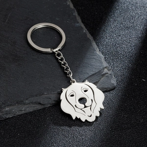 Polished stainless steel dog pendant keychain featuring a hollow animal design on rock