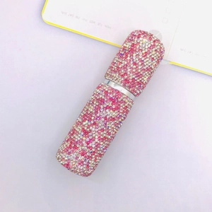 Close-up of pink and white rhinestones on a 10ml travel perfume atomizer spray bottle