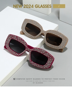 Detail of burgundy and champagne cat eye sunglasses with shimmering rhinestones and large frames