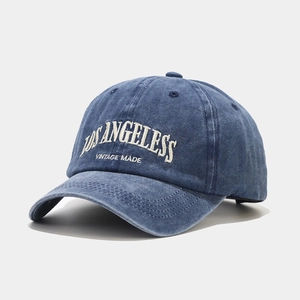 Detailed close-up of vintage washed navy cotton baseball cap with Los Angeles embroidery