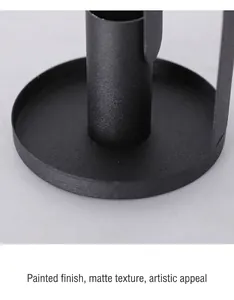 Detail of black matte wrought iron candle holder base with textured powder coating