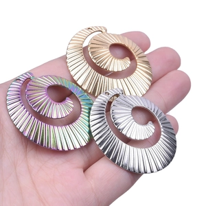 Detailed close-up of spiral textured metal pendants in gold, silver, and rainbow finishes