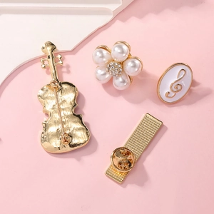 Elegant gold-tone brooch set featuring violin, pearl flower and musical notes shapes