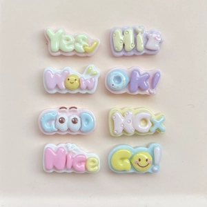 Macro detail of 8 colorful resin charms featuring 3D English words like GOOD and NICE
