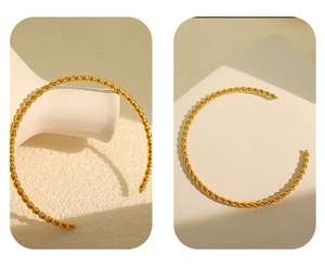 Detailed close-up of golden twisted cuff bracelet featuring an adjustable open design
