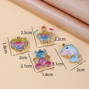 Sparkly resin cartoon charms with gold frames showing heart, crown, bear and dolphin shapes