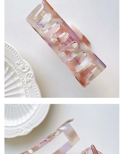 Detail of pink marble acetate hair claw clip with minimalist rectangular cutout design