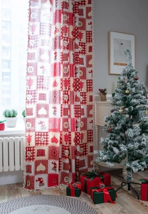 Detailed view of Christmas patchwork curtains with tassels and festive tree ornaments