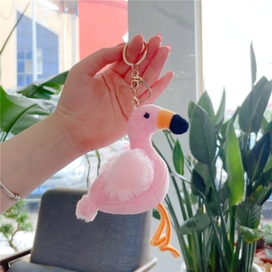 Detailed view of pink flamingo plush keychain with golden metal ring and lobster clasp