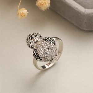 Detailed close-up of a silver owl ring encrusted with black and white zircon stones